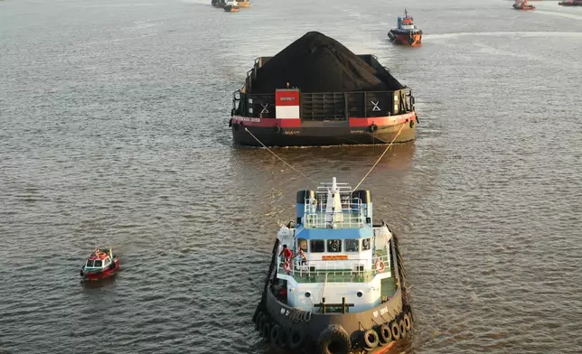 A tug boat pulls a barge loaded with coal on the Mahakam River in Samarinda, East Kalimantan, Indonesia, on Aug. 19, 2026. (AP Photo/Ahmad Mulia Panjaitan)