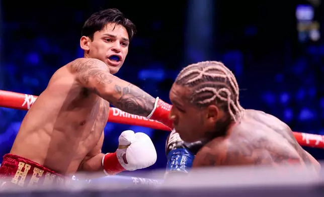 Ryan Garcia, left, punches Conor Benn in their welterweight championship fight Saturday, Sept. 12, 2026, in Las Vegas. (AP Photo/Ian Maule)