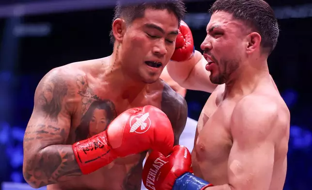Andres Cortes, right, punches Mark Magsayo in their lightweight fight Saturday, Sept. 12, 2026, in Las Vegas. (AP Photo/Ian Maule)