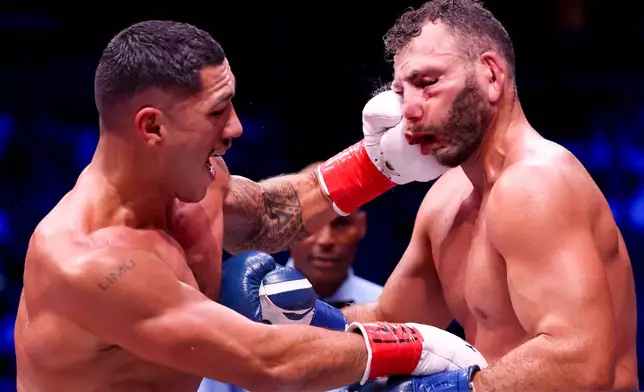 Jai Opetaia, left, punches Noel Mikaelian in their cruiserweight championship fight Saturday, Sept. 12, 2026, in Las Vegas. (AP Photo/Ian Maule)
