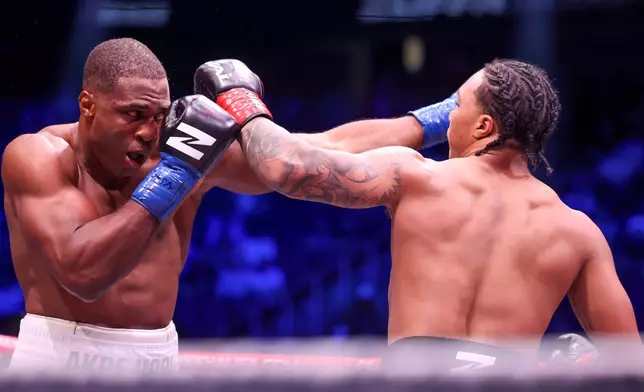 Raphael Akpejiori, (L), fights Da'mazion Vanhouter in their heavyweight fight Saturday, Sept. 12, 2026, in Las Vegas. (AP Photo/Ian Maule)