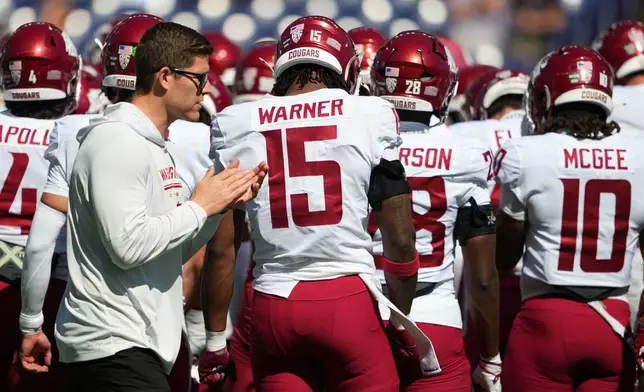 Washington State head coach Kirby Moore claps before an NCAA college football game against Washington, Sunday, Sept. 6, 2026, in Seattle. (AP Photo/Lindsey Wasson)