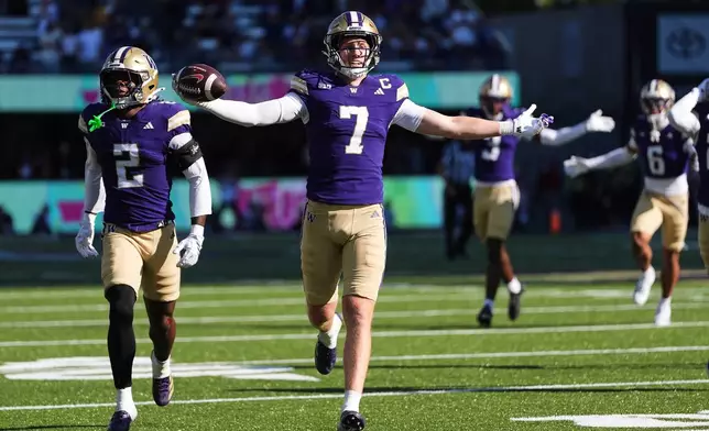 Washington safety Alex McLaughlin (7) celebrates making an interception against Washington State during the second half of an NCAA college football game, Sunday, Sept. 6, 2026, in Seattle. (AP Photo/Lindsey Wasson)