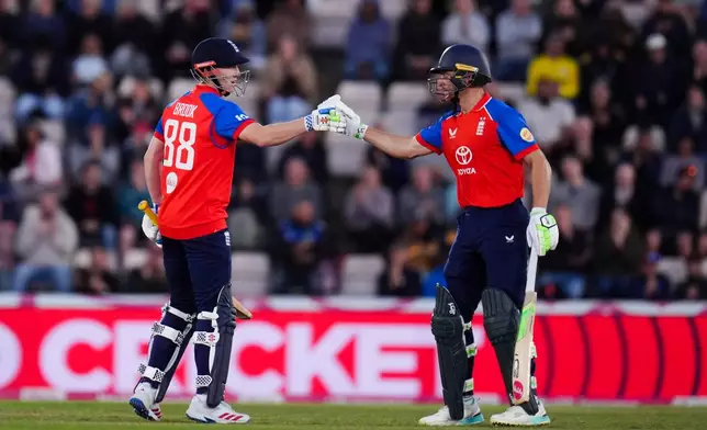 England's Harry Brook, left, celebrates his half century with Jos Buttler during the first IT20 match between England and Sri Lanka in Southampton, England, Tuesday Sept. 15, 2026. (John Walton/PA via AP)