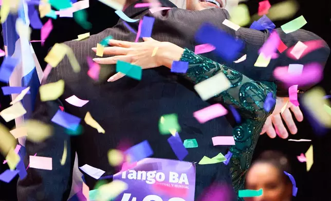 Naima Gerasopoulou of Greece and Lucas Gauto of Argentina celebrate winning the salon category at the Tango World Championship in Buenos Aires, Argentina, Tuesday, Sept. 1, 2026. (AP Photo/Rodrigo Abd)