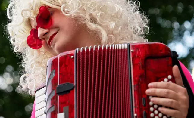 A musician plays an accordion during a parade honoring the late Dolly Parton, Friday, Sept. 4, 2026, in Knoxville, Tenn. (AP Photo/Camden Hall)
