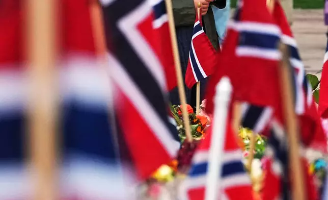 Five-year-old Sophie arrives at Palace Square in Oslo to lay down flower tributes to Norway's late King Harald in Oslo, Norway, Monday, Sept. 7, 2026. (AP Photo/Markus Schreiber)