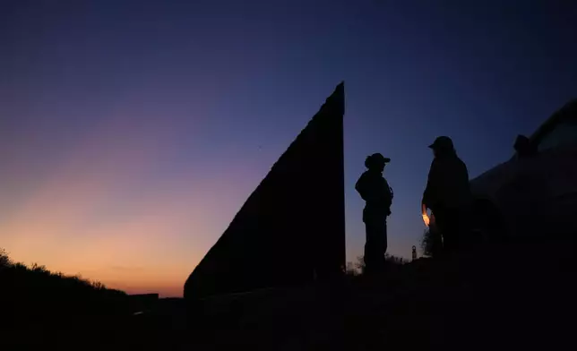 A U.S. Border Patrol agent stands near a new section of border wall at the Santa Ana Wildlife Refuge in Alamo, Texas, Tuesday, Aug. 25, 2026. (AP Photo/Eric Gay)