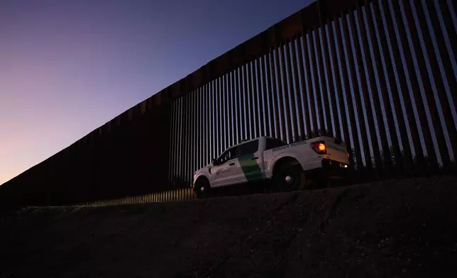 A U.S. Border Patrol vehicle passes a new section of border wall at the Santa Ana Wildlife Refuge in Alamo, Texas, Tuesday, Aug. 25, 2026. (AP Photo/Eric Gay)
