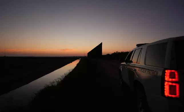 A U.S. Border Patrol vehicle sits near a new section of border wall at the Santa Ana Wildlife Refuge in Alamo, Texas, Tuesday, Aug. 25, 2026. (AP Photo/Eric Gay)