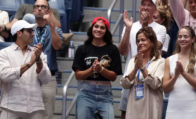 Soccer player Trinity Rodman, center, reacts after her boyfriend Ben Shelton, of the United States, lost the men's singles final of the U.S. Open tennis championships against Alexander Zverev, of Germany, Sunday, Sept. 13, 2026, in New York. (AP Photo/Adam Hunger)