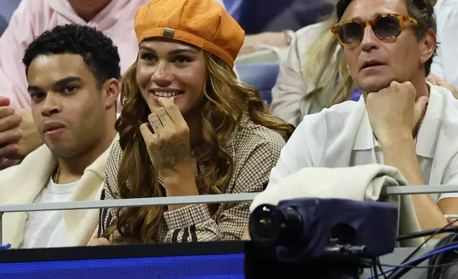 American soccer player Trinity Rodman, center, watches her boyfriend Ben Shelton, of the United States, play Carlos Alcaraz, of Spain, in the quarterfinal round of the U.S. Open tennis championships, Tuesday, Sept. 8, 2026, in New York.(AP Photo/Heather Khalifa)