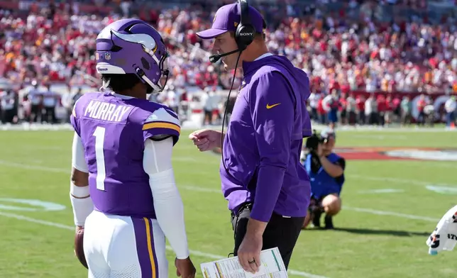 Minnesota Vikings quarterback Kyler Murray (1) and head coach Kevin O'Connell talk during the first half of an NFL football game against the Tampa Bay Buccaneers in Tampa, Fla., Sunday, Sept. 27, 2026. (AP Photo/Chris O'Meara)