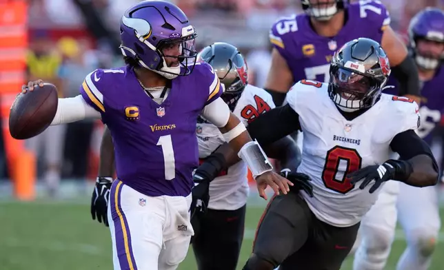 Minnesota Vikings quarterback Kyler Murray (1) looks to pass while pressured by Tampa Bay Buccaneers linebacker Yaya Diaby (0) during the second half of an NFL football game in Tampa, Fla., Sunday, Sept. 27, 2026. (AP Photo/Chris O'Meara)