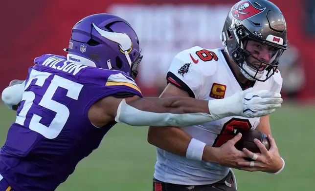 Tampa Bay Buccaneers quarterback Baker Mayfield (6) is tackled by Minnesota Vikings linebacker Eric Wilson (55) during the second half of an NFL football game in Tampa, Fla., Sunday, Sept. 27, 2026. (AP Photo/Chris O'Meara)
