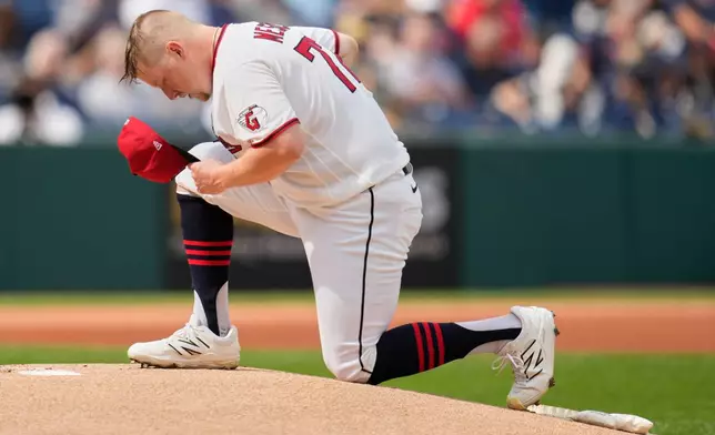 Cleveland Guardians' Parker Messick kneels on the pitching mound before a baseball game against the Chicago White Sox in Cleveland, Wednesday, Sept. 16, 2026. (AP Photo/Sue Ogrocki)