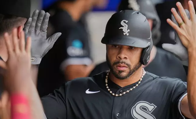 Chicago White Sox's Tommy Pham is congratulated in the dugout after hitting a three-run home run in the fifth inning of a baseball game against the Cleveland Guardians in Cleveland, Wednesday, Sept. 16, 2026. (AP Photo/Sue Ogrocki)