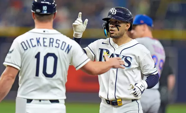 Tampa Bay Rays' Victor Mesa Jr., right, celebrates with first base coach Corey Dickerson after his single off New York Mets pitcher Sean Manaea during the fourth inning of a baseball game Tuesday, Sept. 1, 2026, in St. Petersburg, Fla. (AP Photo/Chris O'Meara)