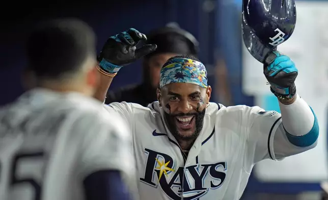 Tampa Bay Rays' Yandy Díaz celebrates in the dugout after his solo home run off New York Mets pitcher Sean Manaea during the sixth inning of a baseball game Tuesday, Sept. 1, 2026, in St. Petersburg, Fla. (AP Photo/Chris O'Meara)