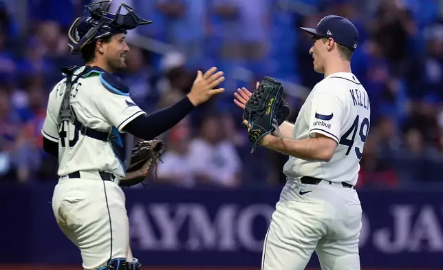 Tampa Bay Rays pitcher Kevin Kelly (49) celebrates with catcher Nick Fortes after closing out the New York Mets during the ninth inning of a baseball game Tuesday, Sept. 1, 2026, in St. Petersburg, Fla. (AP Photo/Chris O'Meara)