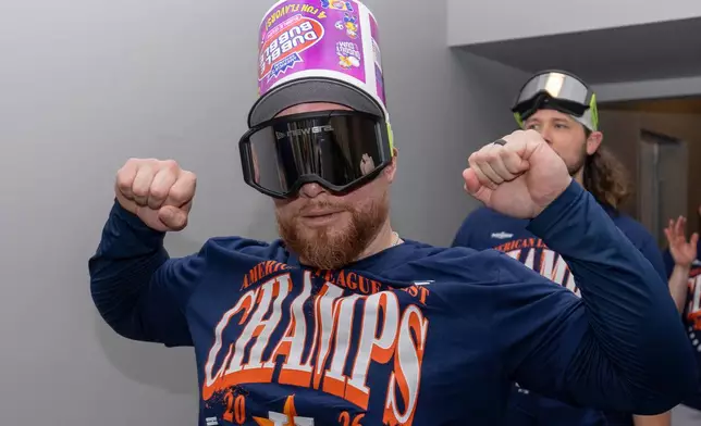 Houston Astros' Christian Vázquez walks to the batting cages for a celebration after the team clinched the AL West division title in a baseball game against the Athletics, Sunday, Sept. 27, 2026, in West Sacramento, Calif. (AP Photo/Sara Nevis)