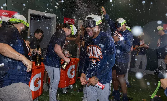 Houston Astros' Brice Matthews, center, celebrates with teammates after clinching the AL West division title in a baseball game against the Athletics, Sunday, Sept. 27, 2026, in West Sacramento, Calif. (AP Photo/Sara Nevis)