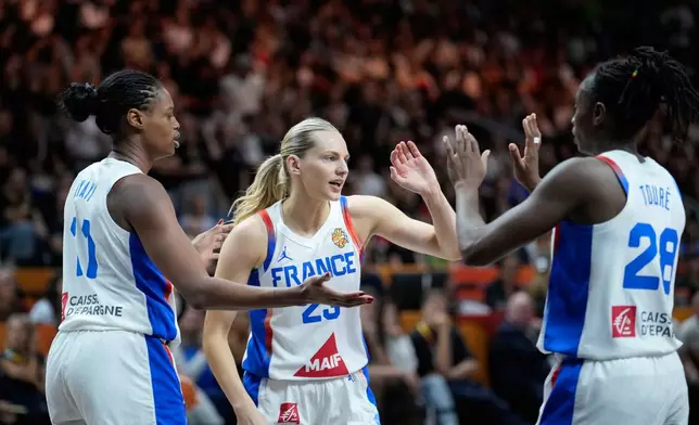 France's Valeriane Ayayi, left, Marine Johannes, center, and Mamignan Toure react during the Women's Basketball World Cup semifinal match between France and Germany in Berlin, Saturday, Sept. 12, 2026. (AP Photo/Ebrahim Noroozi)