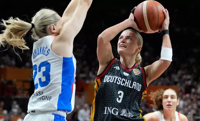 France's Marine Johannes guards Germany's Alexandra Wilke during the Women's Basketball World Cup semifinal match between France and Germany in Berlin, Saturday, Sept. 12, 2026. (AP Photo/Ebrahim Noroozi)