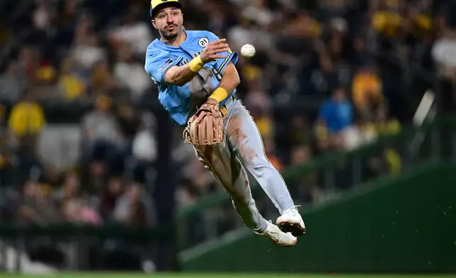 Milwaukee Brewers third baseman David Hamilton throws to first base to get out Pittsburgh Pirates' Konnor Griffin during the fifth inning of a baseball game, Tuesday, Sept. 15, 2026, in Pittsburgh. (AP Photo/David Dermer)