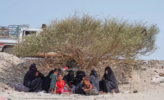 Displaced Yemenis sit outside at Al-Firdaws camp in Ras Imran, on the western outskirts of Aden, Yemen, Thursday, Sept. 24, 2026. (AP Photo/Abdulnasser Alseddik)
