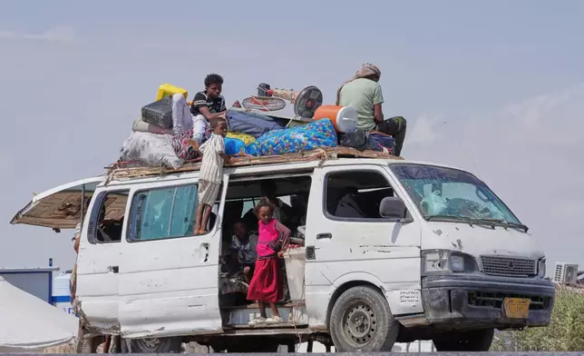 Members of the Haj Ali Araj family, who displaced from Mokha, arrive at Al-Firdaws camp in Ras Imran, on the western outskirts of Aden, Yemen, Thursday, Sept. 24, 2026. (AP Photo/Abdulnasser Alseddik)