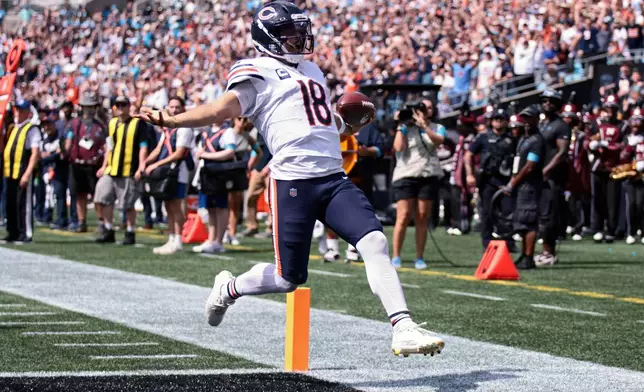 Chicago Bears quarterback Caleb Williams (18) runs to score a touchdown during the first half of an NFL football game, Sunday, Sept. 13, 2026, in Charlotte, N.C. (AP Photo/Scott Kinser)
