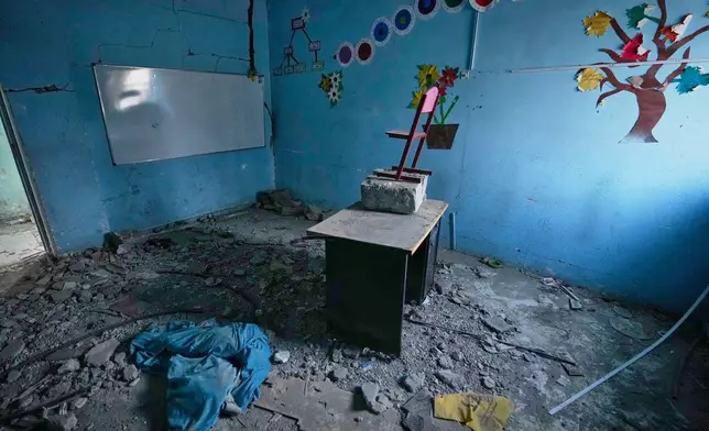 Colorful tree and flower decorations remain on the walls of a rubble-strewn classroom at Shajareh Tayyebeh school, damaged in a U.S. airstrike on Feb. 28, in Minab, southern Iran, Monday, Sept. 7, 2026. (AP Photo/Vahid Salemi)