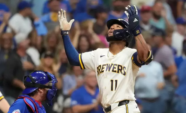 Milwaukee Brewers' Jackson Chourio gestures as he rounds the bases after hitting a two-run home during the ninth inning of a baseball game against the Chicago Cubs, Tuesday, Sept. 8, 2026, in Milwaukee. (AP Photo/Aaron Gash)