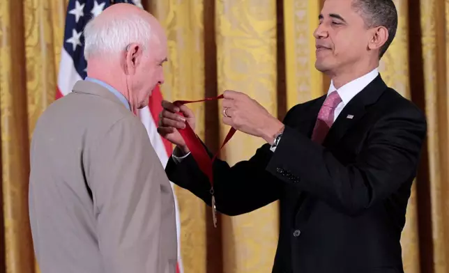 FILE - President Barack Obama presents a National Humanities Medal to poet, novelist, farmer and conservationist, Wendell E. Berry, March 2, 2011, during a ceremony in the East Room of the White House in Washington. (AP Photo/Pablo Martinez Monsivais, File)
