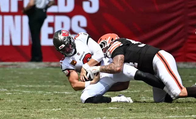 Cleveland Browns defensive tackle Mason Graham (94) sacks Tampa Bay Buccaneers quarterback Baker Mayfield (6) during the first half of an NFL football game in Tampa, Fla., Sunday, Sept. 20, 2026. (AP Photo/Jason Behnken)