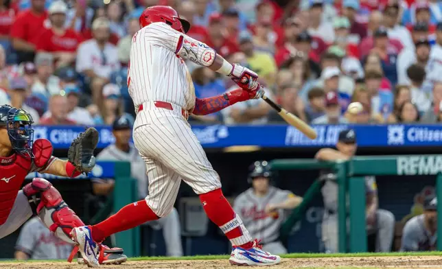 Philadelphia Phillies designated hitter Kyle Schwarber hits a solo home run during the fourth inning of a baseball game against the Atlanta Braves, Saturday, Sept. 5, 2026, in Philadelphia. (AP Photo/Laurence Kesterson)