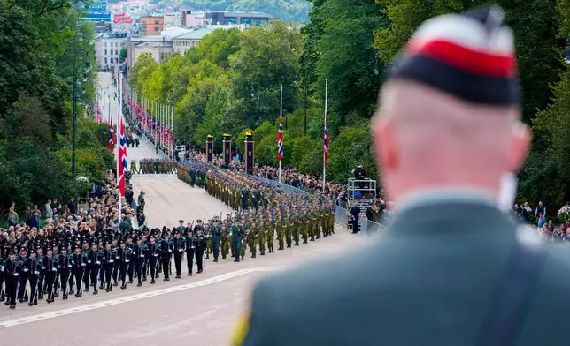 Soldiers march up Karl Johan before the coffin of King Harald V is carried from the Palace to Oslo Cathedral, on Wednesday, Sept. 9, 2025. (Ole Berg-Rusten/NTB Scanpix via AP)