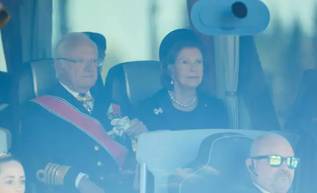 Sweden's King Carl Gustaf and Queen Silvia on board a bus at Oslo Airport as they arrive for King Harald V funeral, Wednesday, Sept. 9, 2026. (Frederik Ringnes/NTB Scanpix via AP)
