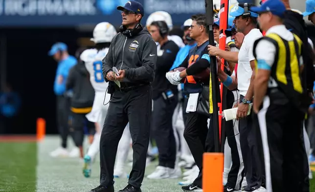 Los Angeles Chargers head coach Jim Harbaugh watches from the sideline during the first half of an NFL football game against the Buffalo Bills, Sunday, Sept. 27, 2026, in Orchard Park, N.Y. (AP Photo/Matt Rourke)