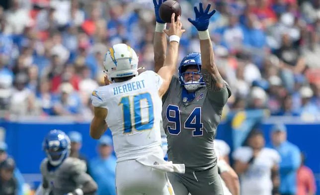 Buffalo Bills defensive end Landon Jackson (94) pressures Los Angeles Chargers quarterback Justin Herbert (10) during the first half of an NFL football game, Sunday, Sept. 27, 2026, in Orchard Park, N.Y. (AP Photo/Adrian Kraus)