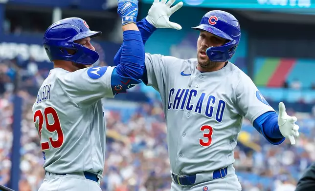 Chicago Cubs designated hitter Alex Bregman (3) celebrates with teammate Michael Busch (29) after hitting his second home run of a baseball game in the third inning against the Boston Red Sox, Sunday, Sept. 27, 2026, in St. Petersburg, Fla. (AP Photo/Chris Urso)