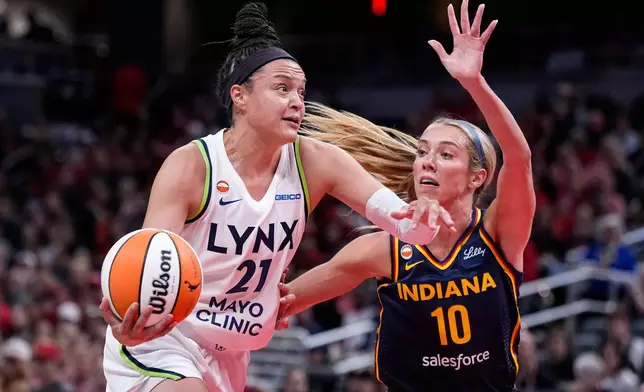 Minnesota Lynx guard Kayla McBride (21) drives on Indiana Fever guard Lexie Hull (10) in the first half of a WNBA basketball game in Indianapolis, Tuesday, Sept. 22, 2026. (AP Photo/Michael Conroy)