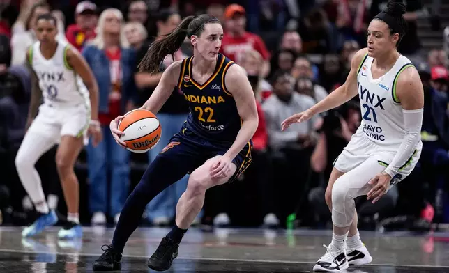 Minnesota Lynx guard Kayla McBride (21) defends Indiana Fever guard Caitlin Clark (22) in the first half of a WNBA basketball game in Indianapolis, Tuesday, Sept. 22, 2026. (AP Photo/Michael Conroy)