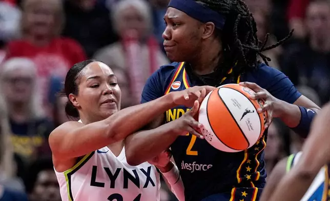 Minnesota Lynx forward Napheesa Collier (24) fouls Indiana Fever forward Myisha Hines-Allen, right, in the first half of a WNBA basketball game in Indianapolis, Tuesday, Sept. 22, 2026. (AP Photo/Michael Conroy)