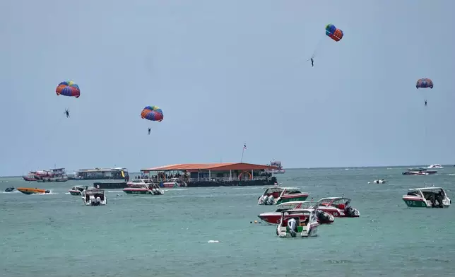 Tourists parasail on Pattaya Beach in Thailand, on Aug. 31, 2026. (AP Photo/Sakchai Lalit)