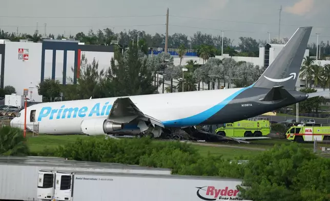 An Amazon cargo plane sits at the Miami International Airport (MIA) after it overshot the runway, Sunday, Sept. 6, 2026. (AP Photo/Lynne Sladky)