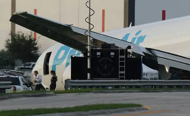 An Amazon cargo plane sits at the Miami International Airport (MIA) after it overshot the runway, Sunday, Sept. 6, 2026. (AP Photo/Lynne Sladky)