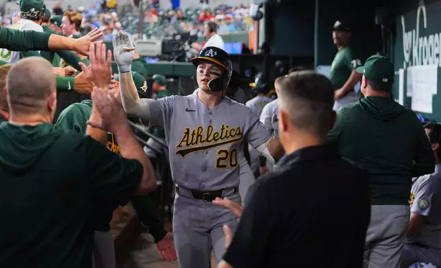Athletics' Zack Gelof is greeted in the dugout after hitting a solo home run off Texas Rangers starting pitcher Cody Bradford during the third inning of a baseball game Wednesday, Sept. 2, 2026, in Arlington, Texas. (AP Photo/Julio Cortez)