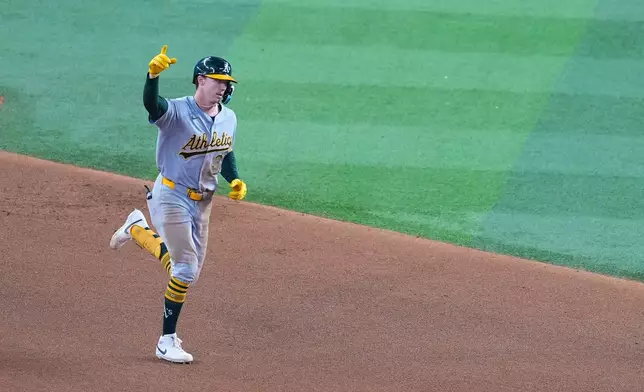 Athletics' Henry Bolte gestures while running the bases after hitting a two-run home run off Texas Rangers starting pitcher Cody Bradford during the fourth inning of a baseball game Wednesday, Sept. 2, 2026, in Arlington, Texas. (AP Photo/Julio Cortez)